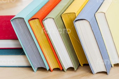 Vintage books in multi-colored covers on a table