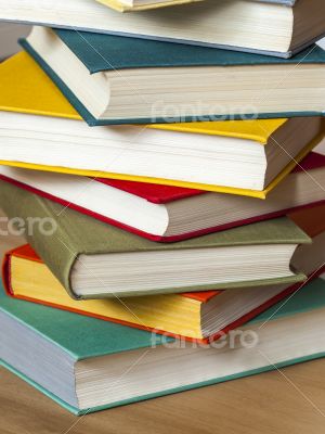 Vintage books in multi-colored covers on a table