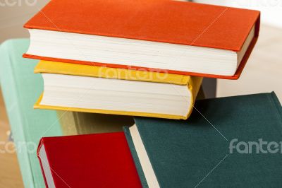 Vintage books in multi-colored covers on a table