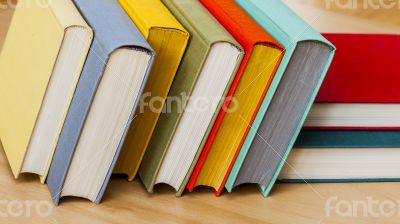 Vintage books in multi-colored covers on a table