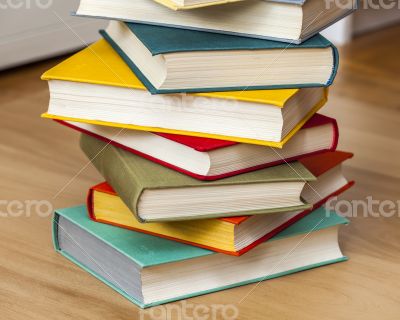 Vintage books in multi-colored covers on a table