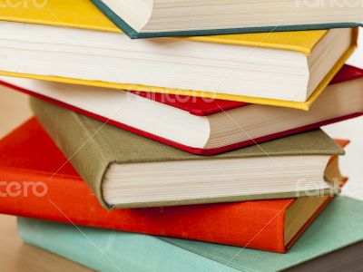 Vintage books in multi-colored covers on a table