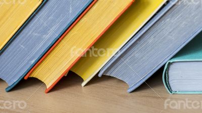 Vintage books in multi-colored covers on a table