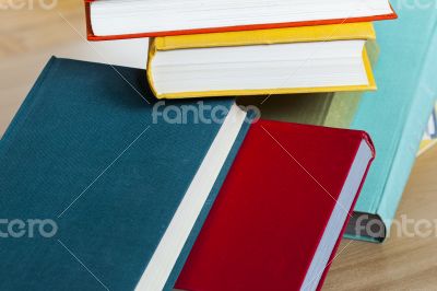 Vintage books in multi-colored covers on a table