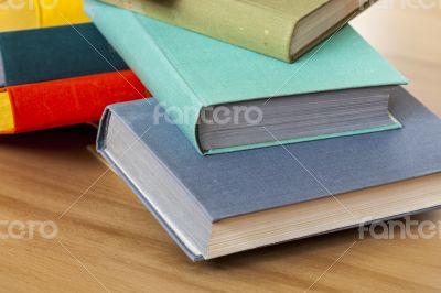 Vintage books in multi-colored covers on a table