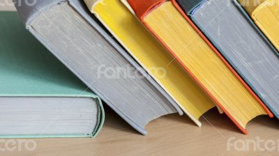 Vintage books in multi-colored covers on a table