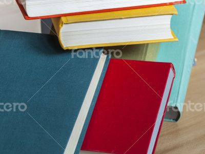 Vintage books in multi-colored covers on a table