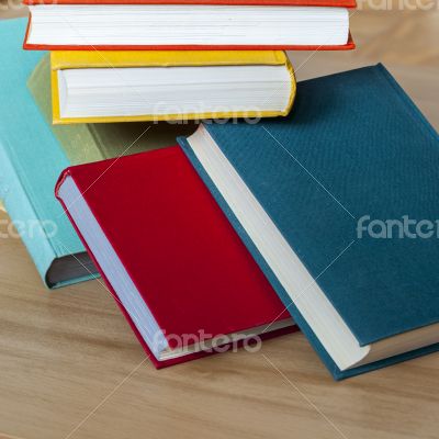 Vintage books in multi-colored covers on a table