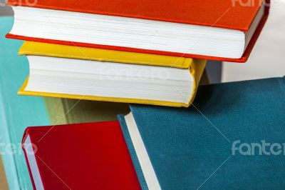 Vintage books in multi-colored covers on a table