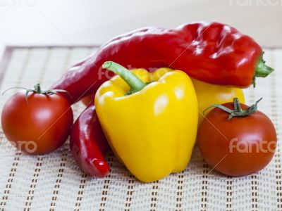 Large paprika of red and yellow color and fresh tomatoes