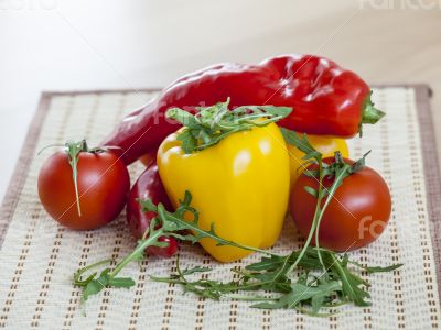 Tomatoes, leaves of arugula and sweet pepper