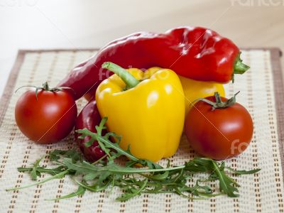 Tomatoes, leaves of arugula and sweet pepper
