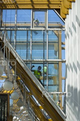 Workers wash a glass wall Workers wash a glass wall