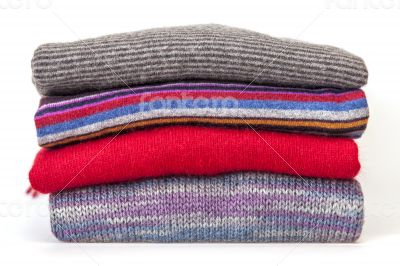 Pile of woolen jumpers of various colors