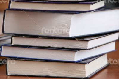 Stack of new books with hard cover spine