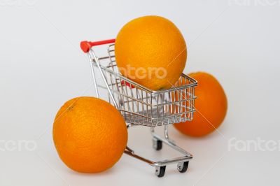 Large bright oranges in the cart for shopping