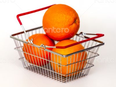 Bright large oranges in a basket for shopping