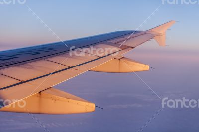 Flight at sunrise. The wing of the plane Flight at sunrise. The wing of the plane