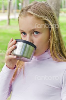 Cute girl drinking beverage