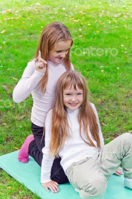 Two girls sitting on grass Two girls sitting on grass