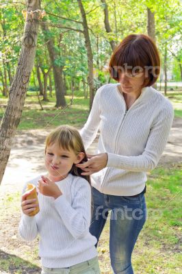 Mother and daughter makes hairstyle