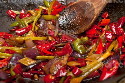 fried chili pepper and vegetable on a wok pan