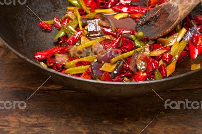 fried chili pepper and vegetable on a wok pan