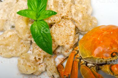 Italian gnocchi with seafood sauce with crab and basil