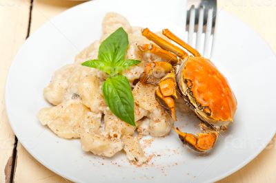 Italian gnocchi with seafood sauce with crab and basil