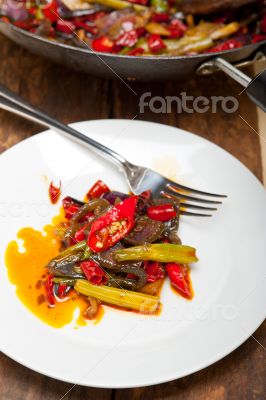 fried chili pepper and vegetable on a wok pan