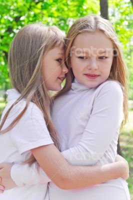 Smiling whispering girls in summer