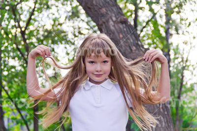 Cute girl playing with long hair