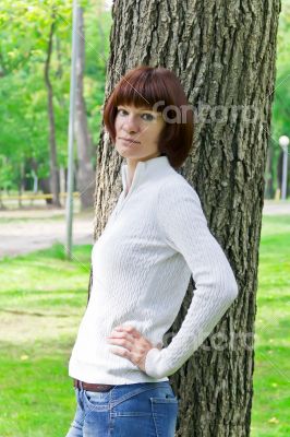 Woman with brown hair near tree