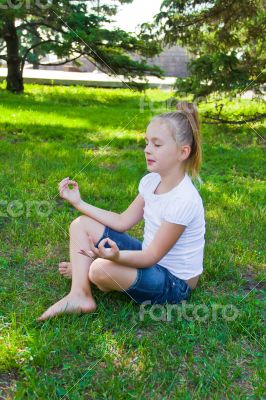 Cute girl in lotus pose