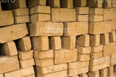 Stack of raw bricks drying in the open air