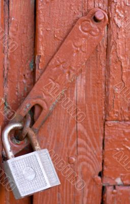 Old lock on red wooden door