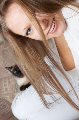 young smiling girl in white with cat