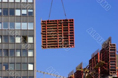Tower crane lifting concrete frame