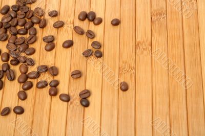 Grains of coffee on a carpet made of a tree