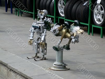 Robot sculpture. Boy and bird