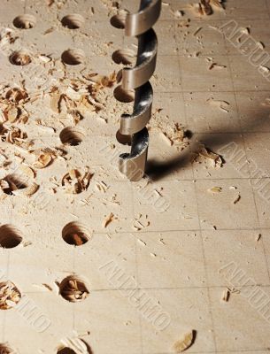 Drilling of apertures in a sheet of plywood