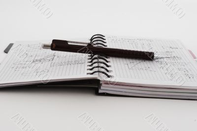 Notebook a pencil on a white background