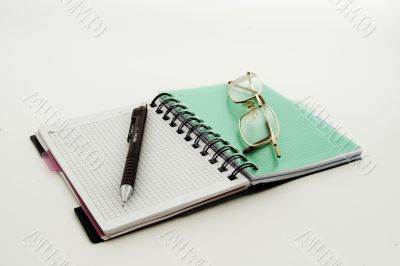 Notebook a pencil glasses style on white