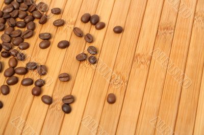 Grains of coffee on a carpet made of a tree