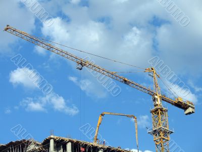 Yellow tower crane on a construction site