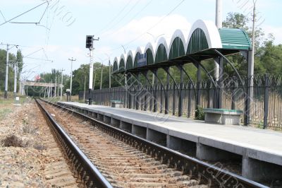 Railway station, rails, wires and a traffic light