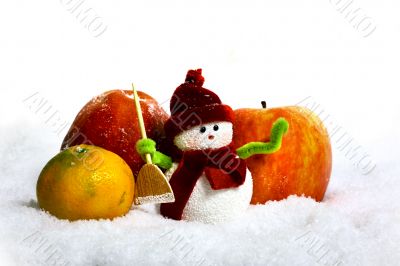 Snowman and apples in snow