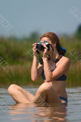 girl with camera in water