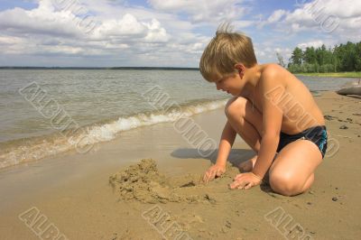 boy, sea and cloudy sky