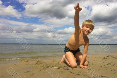 boy, sea and cloudy sky